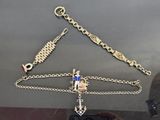 a gold chain with a cross on it and a blue and white cross on it