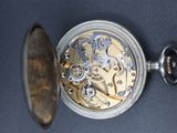 a close up of a pocket watch on a wall