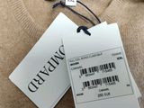 two tags on a sweater hang on the back of a sweater
