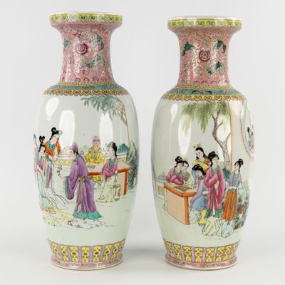 pair of chinese vases decorated with ladies and men in a garden