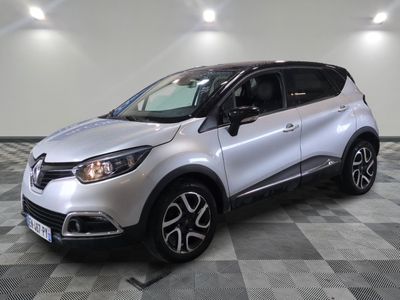 a silver car is parked in a room with a checkered floor