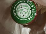 a green cap sitting on top of a piece of paper