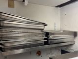 a stack of pans sitting on a shelf in a kitchen