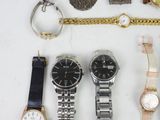 a lot of watches that are laying out on the table