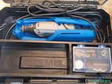 a blue drill in a tool box with other tools in it