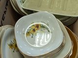 many plates and bowls in a box on the table