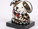 figurine of a dog with a bow tie on a black base