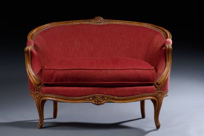 an image of a red chair with a wooden frame and a red upholstered seat