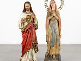 a couple of statues of jesus and mary standing next to each other