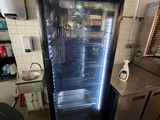 an image of a commercial kitchen with a refrigerator