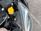 a person that is holding a small yellow object in their hand