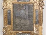 an image of a gold frame with a picture of a woman on it