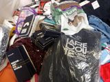a pile of clothes and other items on a bed