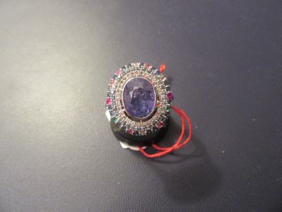 a picture of a broochle with a purple stone in it