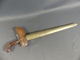 a small wooden sword with a wooden handle on a table