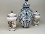 three blue and white vases with lids and lids are sitting on a table