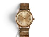 an image of a watch with a gold dial on a white background