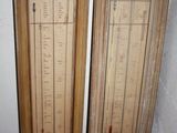 two wooden doors that have a barometer on them