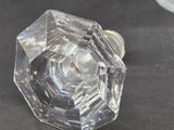 a clear glass knob on a table next to a glass vase