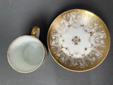 a cup and saucer sitting next to each other on a table