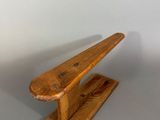 an image of a wooden bench on a gray surface