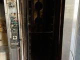 an old oven that is in the middle of a room