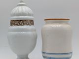 two vases sitting next to each other on a white surface