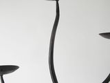 a black candle holder that has three candles on it