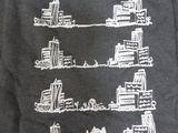a t - shirt that has a picture of a city on it
