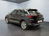 the rear end of a black volkswagen suv parked in a showroom