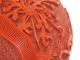 a red vase that has a white elephant on it