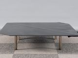 une table noire avec un plateau noir posée sur un sol en damier