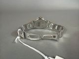 a silver watch that is connected to a white cord