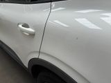 a white car that is parked in a parking lot