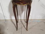 a small table that has a wooden top on it