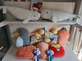 many stuffed animals sitting on a shelf in a room