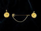 a close up of a gold necklace and a pair of earrings