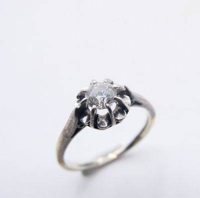 a close up of a diamond ring on a white background