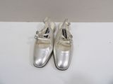 pair of silver shoes sitting on top of a white table