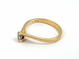 an image of a gold ring with a black diamond on it