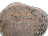 an old, rusty bowl with a hole in it
