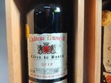 two bottles of wine in a wooden box on a table