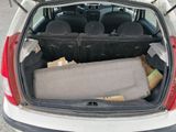 the back of a car with the trunk filled with luggage