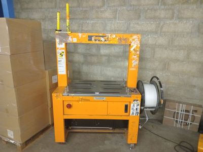 a machine that is sitting in a room with boxes