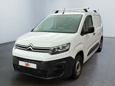 the white van is parked in a large room with a black floor