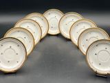 a set of six white and gold china plates with gold trim