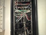 a black cabinet with a bunch of wires in it