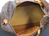 a brown and tan bag on a black surface