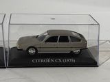 a small car in a clear case on a white surface
