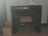 a black fire place in the corner of a room